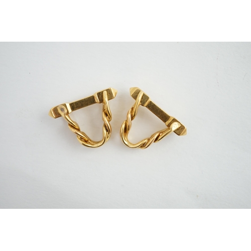 472 - A pair of 18K yellow gold stirrup cufflinks, by Boucheron, (signed and numbered 26504), of twisted c... 