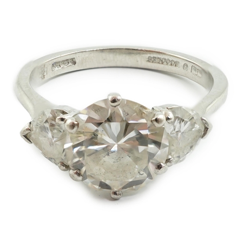 473 - A modern platinum and single stone diamond ring, with two stone heart shaped diamond set shoulders, ... 