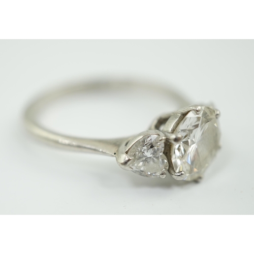 473 - A modern platinum and single stone diamond ring, with two stone heart shaped diamond set shoulders, ... 