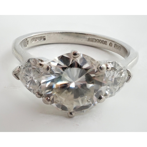 473 - A modern platinum and single stone diamond ring, with two stone heart shaped diamond set shoulders, ... 