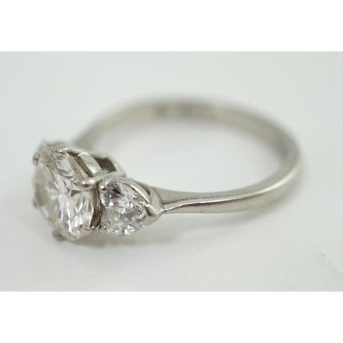 473 - A modern platinum and single stone diamond ring, with two stone heart shaped diamond set shoulders, ... 