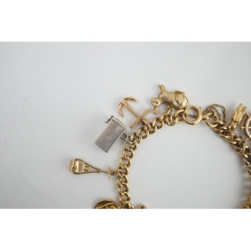 482 - A 18ct gold charm bracelet, hung with fourteen assorted 9ct gold or silver charms, including a pram,... 