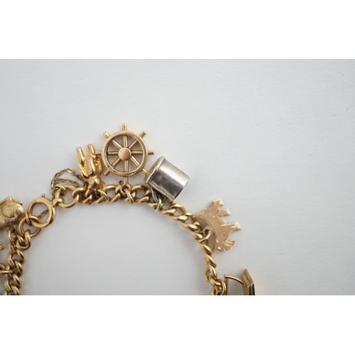 482 - A 18ct gold charm bracelet, hung with fourteen assorted 9ct gold or silver charms, including a pram,... 