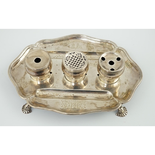 5 - A George II silver inkstand, William Cripps, 1750, the cartouche shaped stand with reeded border, on... 