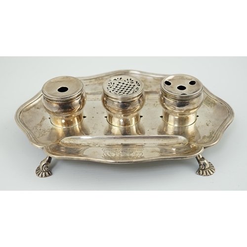 5 - A George II silver inkstand, William Cripps, 1750, the cartouche shaped stand with reeded border, on... 