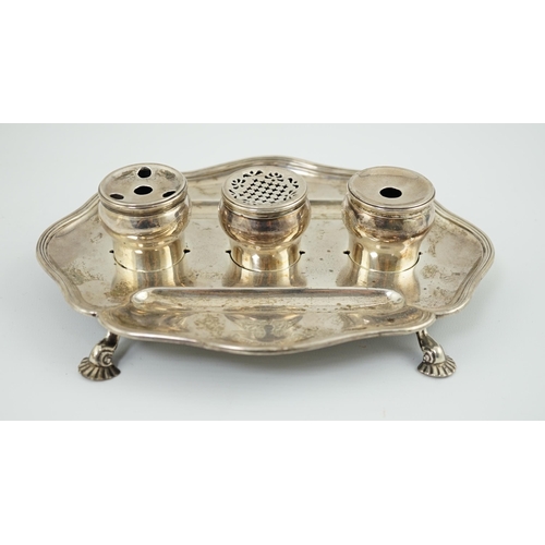 5 - A George II silver inkstand, William Cripps, 1750, the cartouche shaped stand with reeded border, on... 