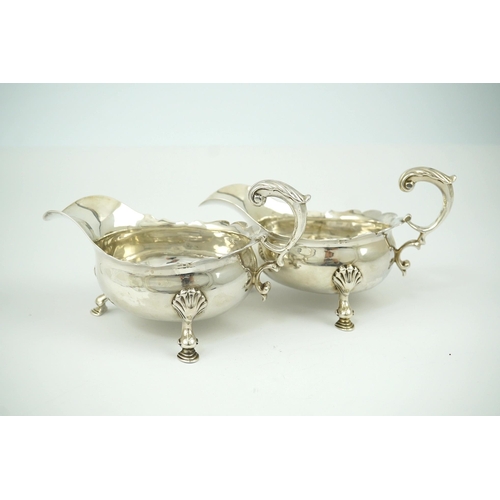 6 - A pair of George II silver sauceboats, by Henry Brind, with flying scroll handles, engraved armorial... 