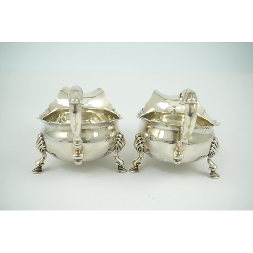 6 - A pair of George II silver sauceboats, by Henry Brind, with flying scroll handles, engraved armorial... 