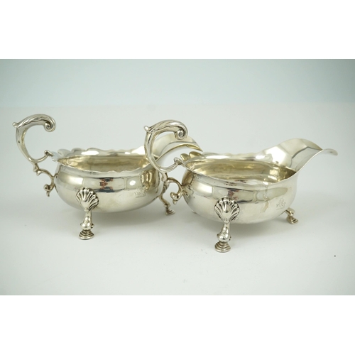 6 - A pair of George II silver sauceboats, by Henry Brind, with flying scroll handles, engraved armorial... 