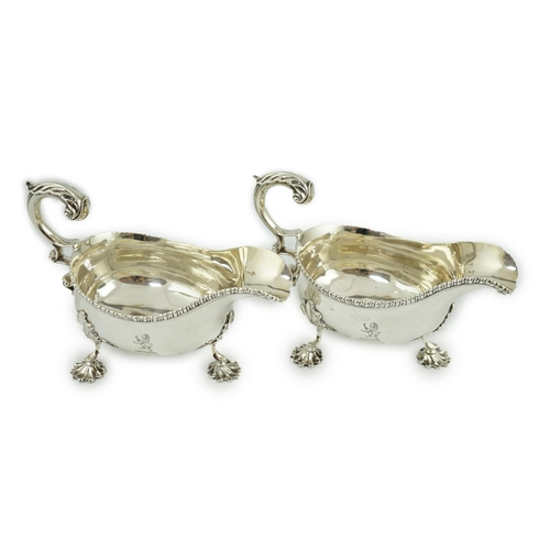 7 - A pair of George III silver sauceboats, by Thomas Evans, with flying scroll handles and engraved arm... 