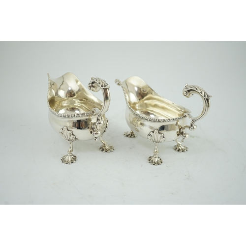 7 - A pair of George III silver sauceboats, by Thomas Evans, with flying scroll handles and engraved arm... 