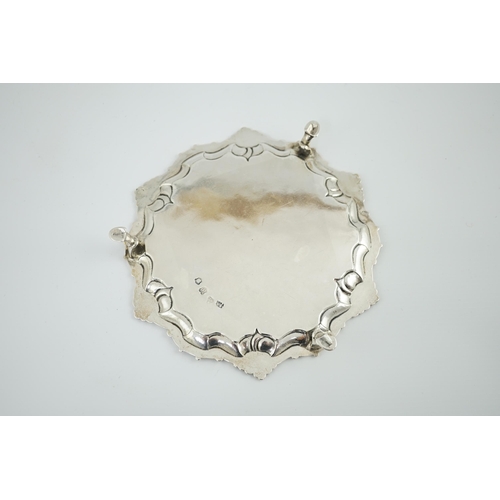 8 - A George II silver waiter, by Samuel Courtauld, of shaped circular form, with shell and scroll borde... 