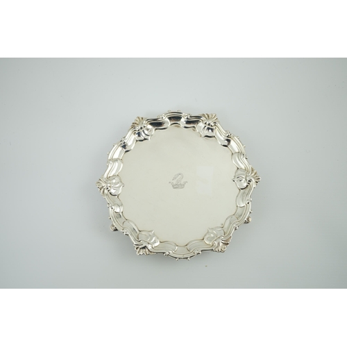 8 - A George II silver waiter, by Samuel Courtauld, of shaped circular form, with shell and scroll borde... 