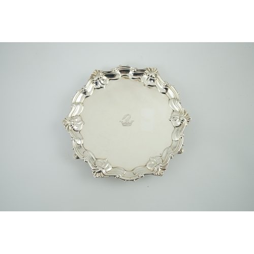 8 - A George II silver waiter, by Samuel Courtauld, of shaped circular form, with shell and scroll borde... 