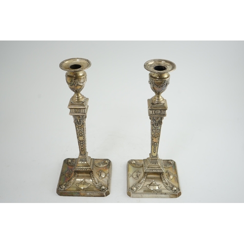 91 - A pair of late Victorian silver Adams style candlesticks, by William Hutton & Sons, with ram's head ... 