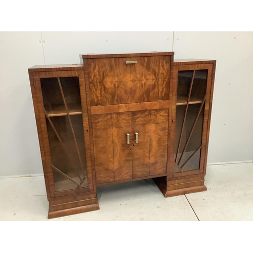 1001 - An Art Deco figured walnut cocktail cabinet, width 136cm, depth 39cm, height 123cm. Condition - one ... 