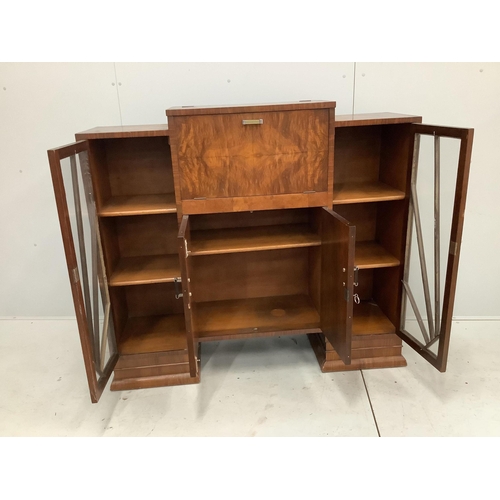 1001 - An Art Deco figured walnut cocktail cabinet, width 136cm, depth 39cm, height 123cm. Condition - one ... 