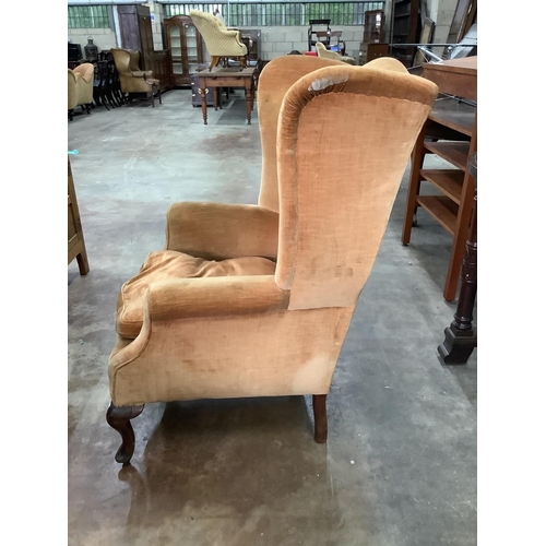 1012 - An early 20th century upholstered wing armchair, width 81cm, depth 72cm, height 110cm. Condition - f... 