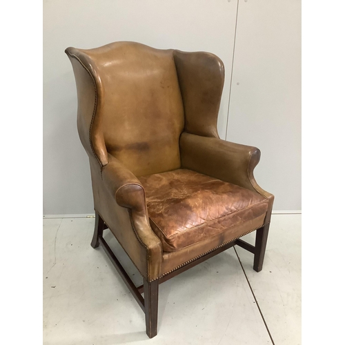 1013 - A George III style tan leather wing armchair, width 80cm, depth 68cm, height 107cm. Condition - fair... 