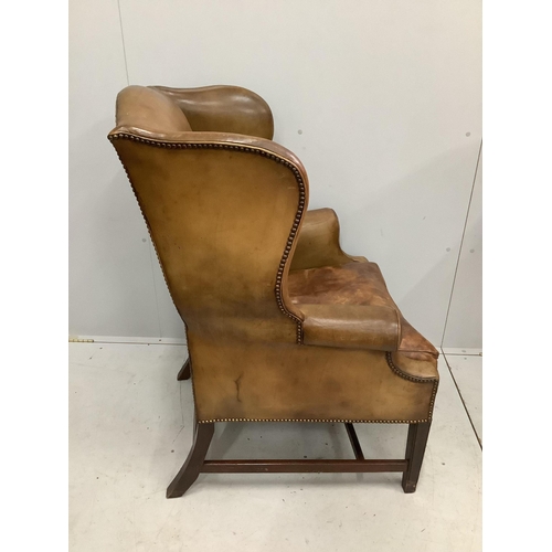 1013 - A George III style tan leather wing armchair, width 80cm, depth 68cm, height 107cm. Condition - fair... 