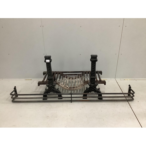 1030 - A pair of black painted cast iron fire dogs, a fire basket and a wrought iron fender. Condition - fa... 