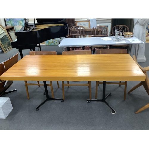 1037 - In the manner of Charlotte Perriand, a mid century rectangular maple dining table on twin three pron... 