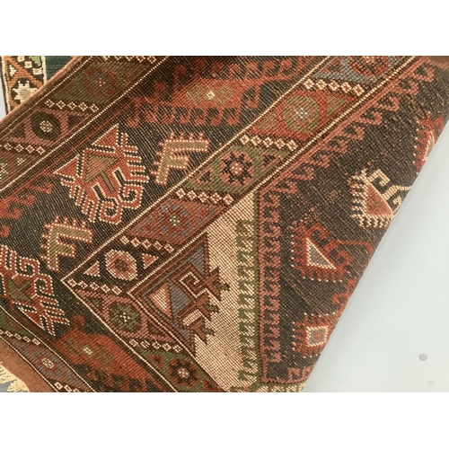 1059 - A Caucasian style multicoloured geometric rug, 190 x 130cm. Condition - fair