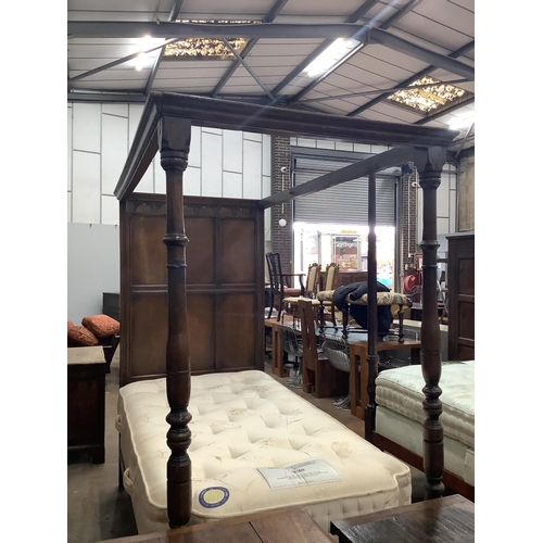 1067 - An 18th century style oak single four poster single bed frame, together with a mattress, width 107cm... 