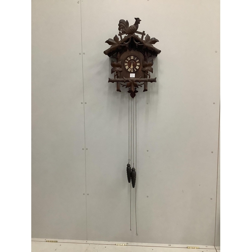 1115 - A Black Forest carved cuckoo clock, height 58cm. Condition - fair