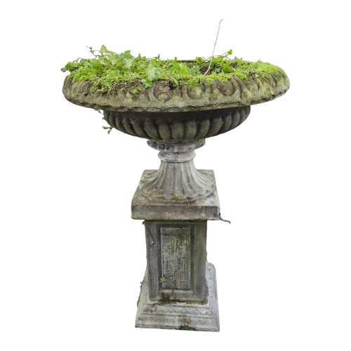 15 - A large reconstituted stone garden vase with fluted sides, on square plinth, 80cm diameter, 116cm hi... 