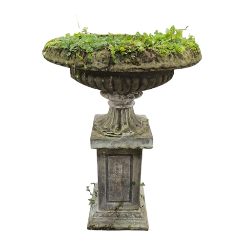 15 - A large reconstituted stone garden vase with fluted sides, on square plinth, 80cm diameter, 116cm hi... 