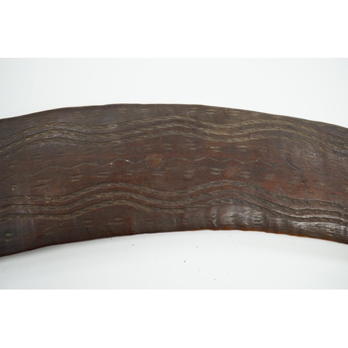 2206 - An Aboriginal boomerang, engraved to one side, 76cm wide. Condition - fair to good