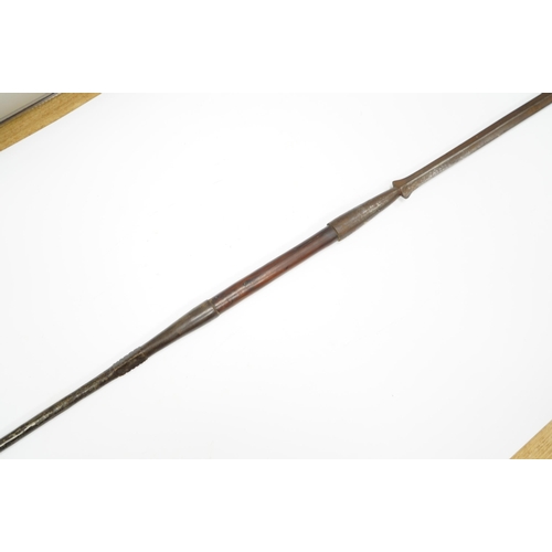 2207 - An African spear, with elongated iron tip and short hardwood shaft, 185cm. Condition fair to good, w... 