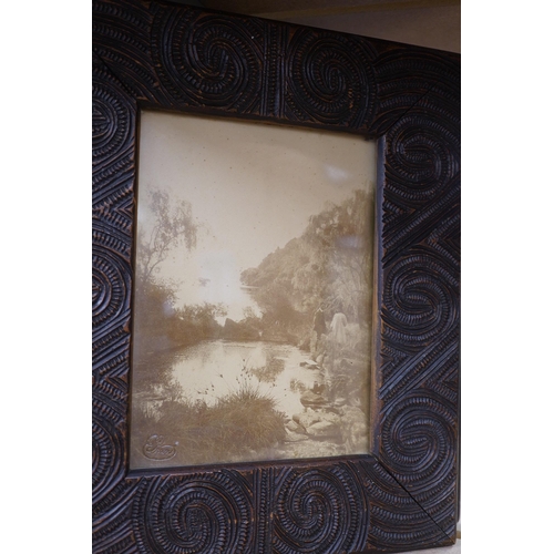 2210 - A pair of Maori carved wood photograph frames containing contemporary New Zealand photographs c.1900... 