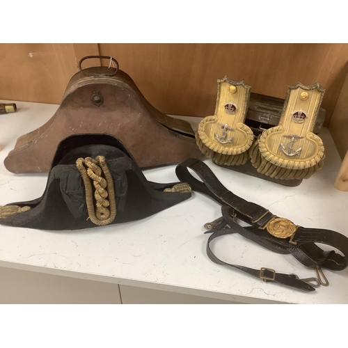 2216 - An early 20th century Royal Naval officers cased bicorn hat, cased Captains bullion work epaulette... 