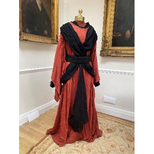 169 - A mens Buddhist style robe in rust linen, with black under-garment and black decorative belt, label... 