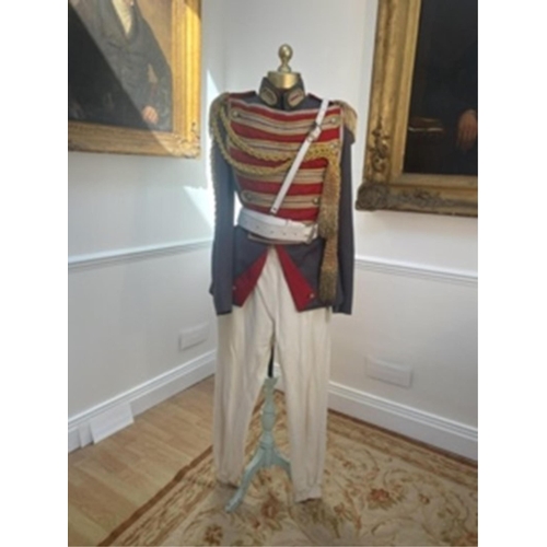 191 - A military style uniform with elaborate trim and epilates and other accessories, cream leggings and ... 