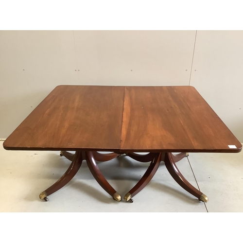 21 - A Regency mahogany twin pillar extending dining table, width approximately 240cm extended, two spare... 