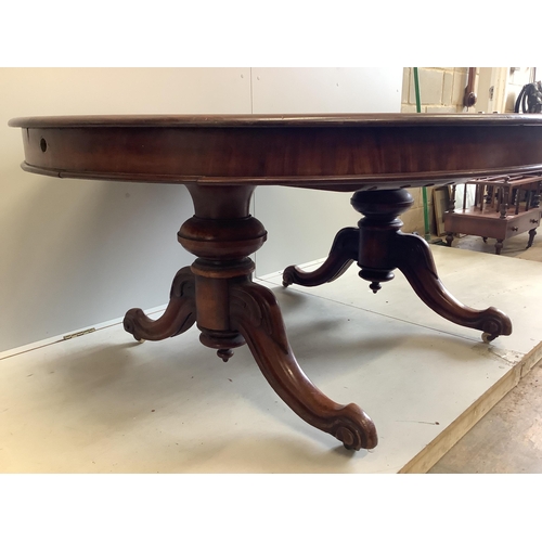 77 - A Victorian mahogany twin pillar extending dining table, 246cm extended, two spare leaves, depth 134... 