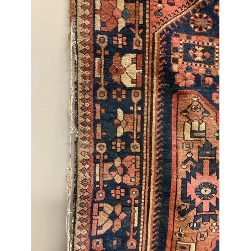 1064 - A Hamadan pink ground rug with a geometric woven hexagonal field, 195 x 156cm. Condition -  poor to ... 