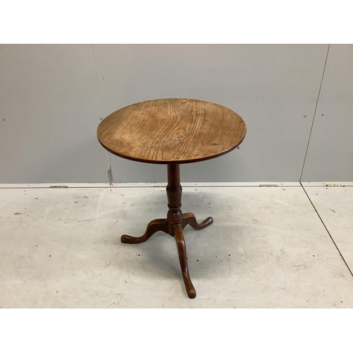 1070 - A George III circular oak tripod table, diameter 58cm, height 66cm. Condition - fair to good