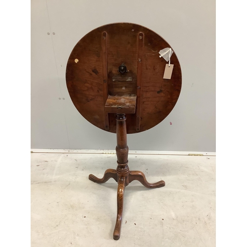 1070 - A George III circular oak tripod table, diameter 58cm, height 66cm. Condition - fair to good