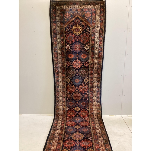 1077 - A North West Persian blue ground runner, 480 x 98cm. Condition - fair