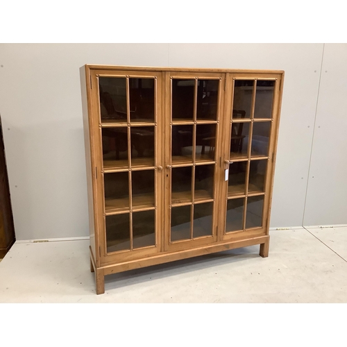 1095 - An early 20th century Heal & Son, London glazed walnut three door bookcase, width 122cm, depth 29cm,... 