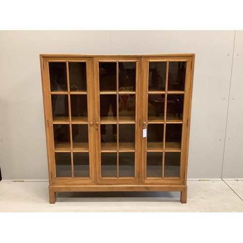 1095 - An early 20th century Heal & Son, London glazed walnut three door bookcase, width 122cm, depth 29cm,... 