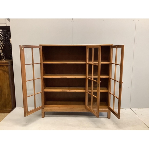 1095 - An early 20th century Heal & Son, London glazed walnut three door bookcase, width 122cm, depth 29cm,... 