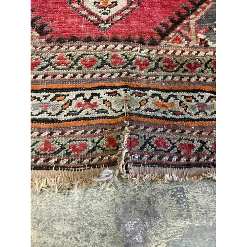 1105 - A Caucasian red ground runner, woven with a row of octagons, 416 x 106cm. Condition - fair