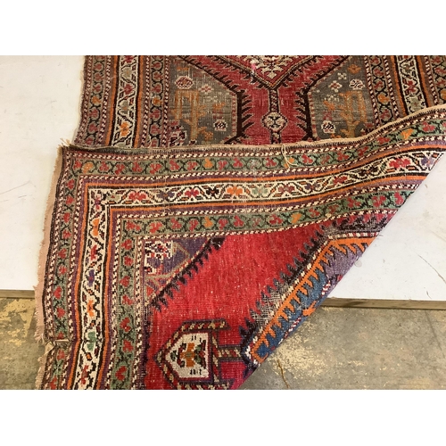 1105 - A Caucasian red ground runner, woven with a row of octagons, 416 x 106cm. Condition - fair