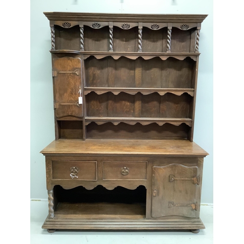 1115 - An early 20th century Liberty style oak dresser, width 157cm, height 208cm. Condition - damage to th... 