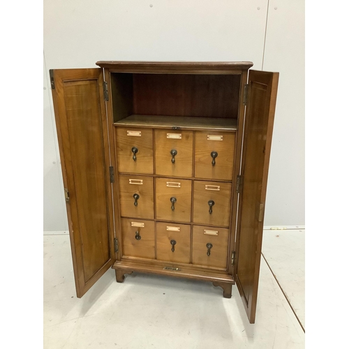 35 - An early 20th century walnut office cabinet fitted with nine deep drawers, width 61cm, height 106cm.... 